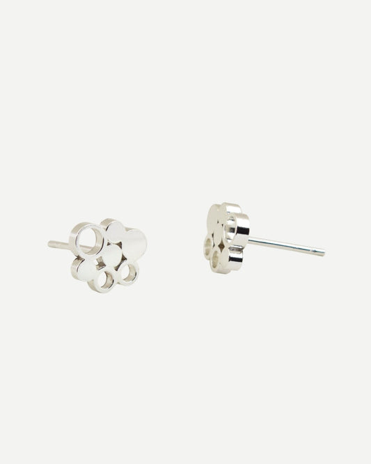Front and side view of small silver stud earrings with circle design on white background