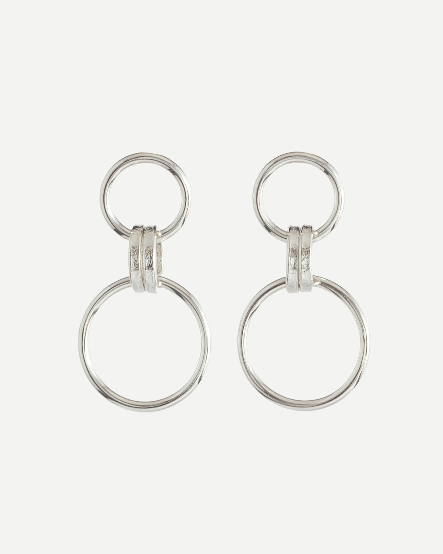 Polished sterling silver earrings with minimalist loop design on white background