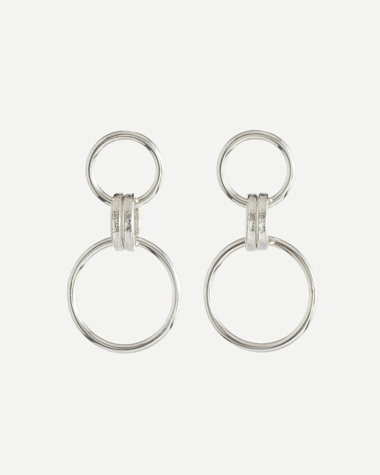 Polished sterling silver earrings with minimalist loop design on white background