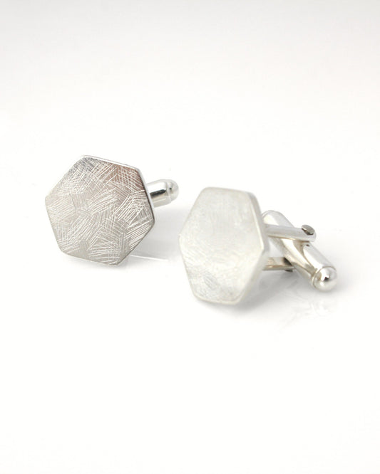 Sterling silver hexagon cufflinks with delicate textured surface on white background