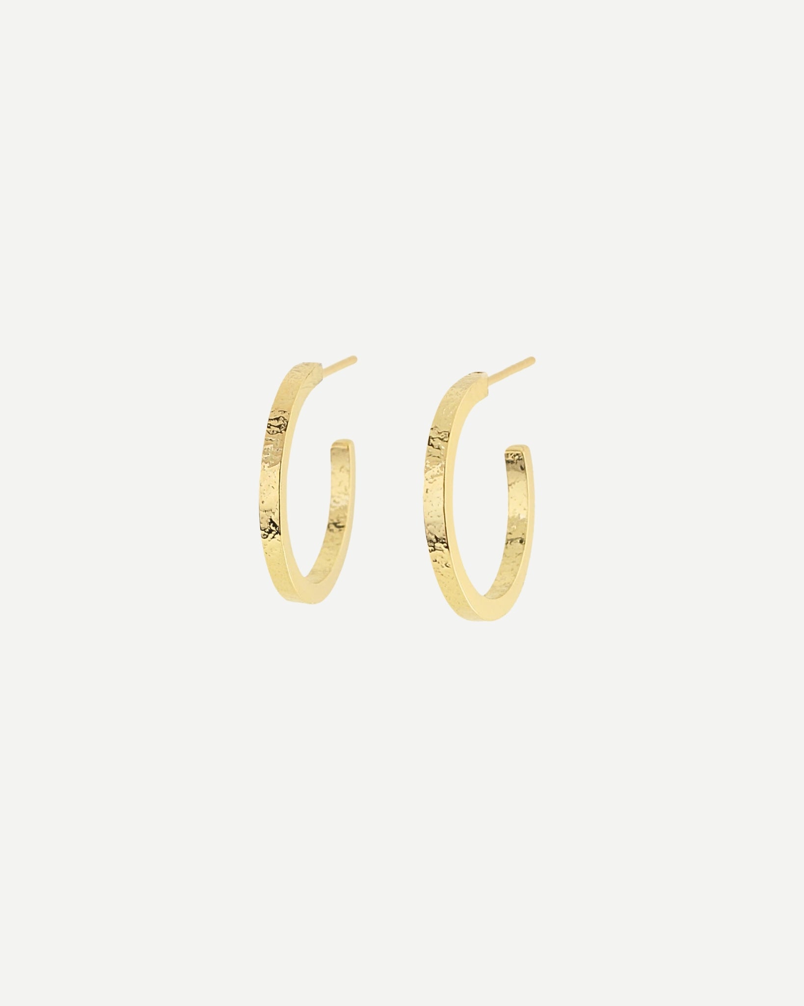Gold hoop earrings with delicate texture on front and back in front of white background