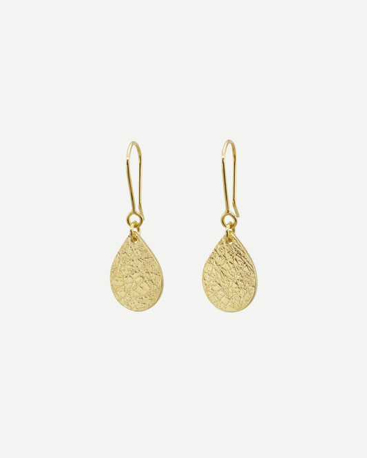 Elegant textured gold teardrops hanging from handmade gold earring hooks on white background