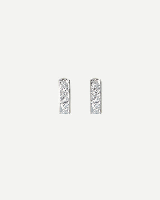 Front view of small textured rectangle stud earrings on white background