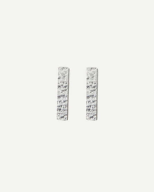 Silver rectangle bar stud earrings with delicate textured surface on white background