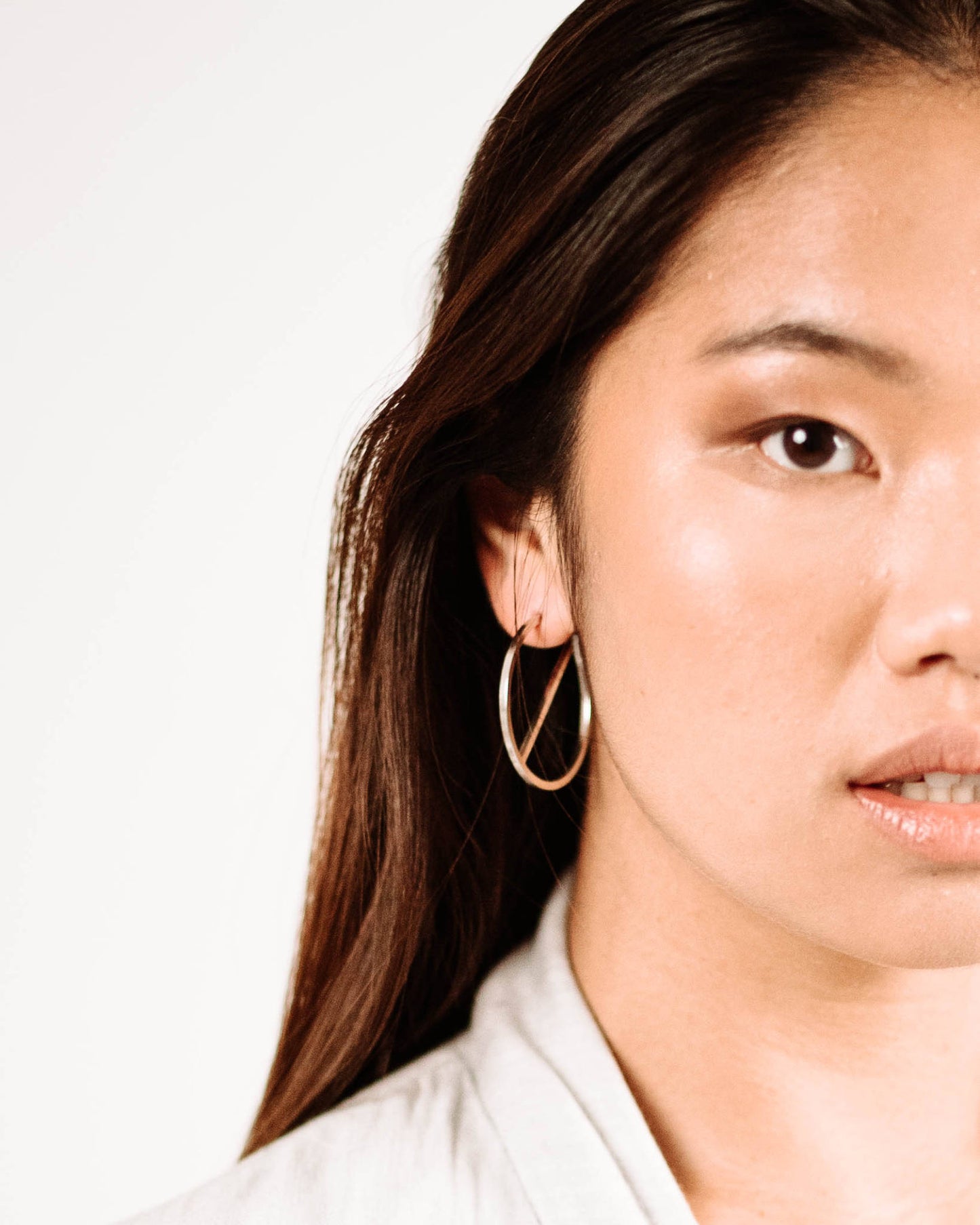 model wearing contemporary sterling silver slice earrings by aurelium nz