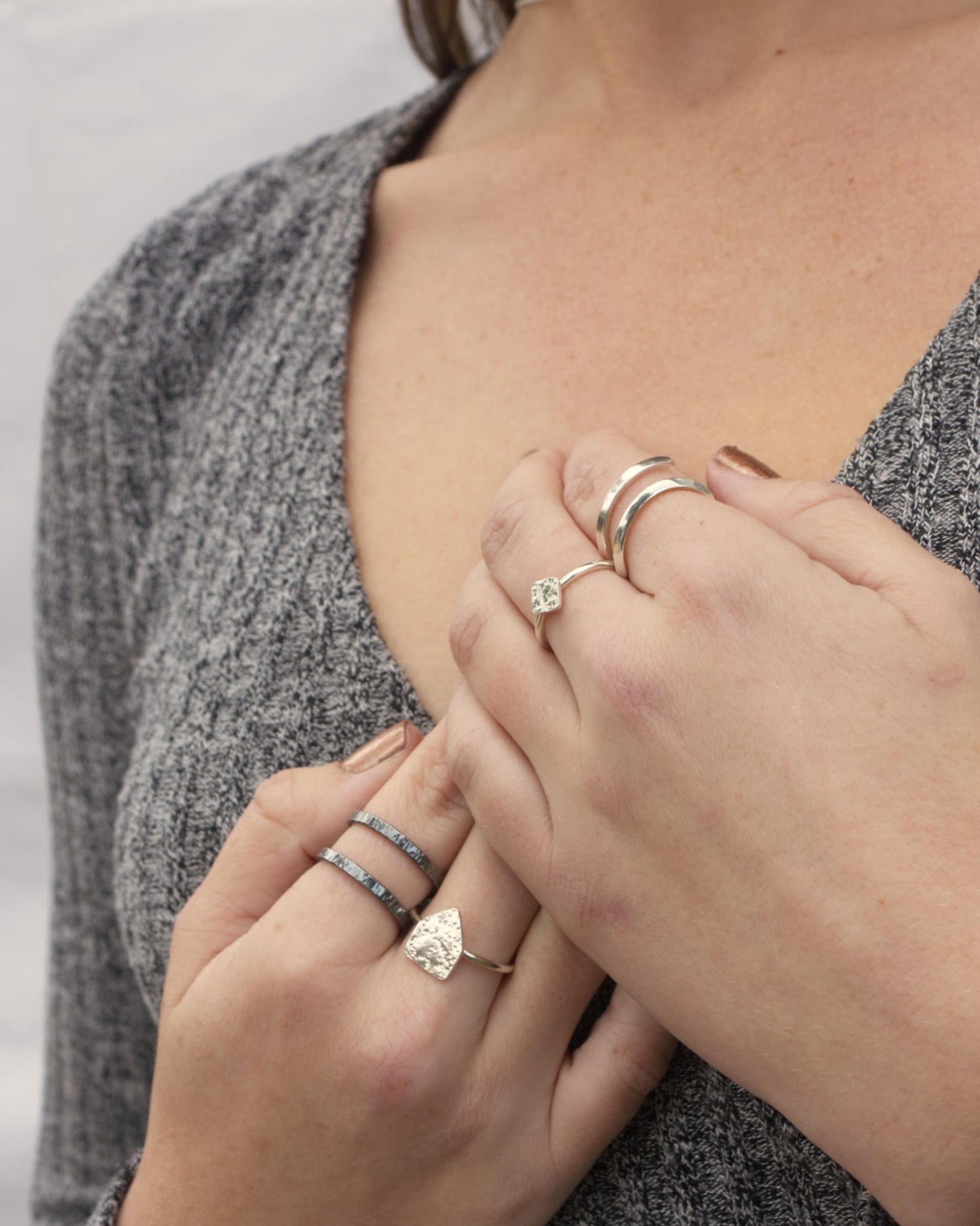 model wearing minimalist adjustable silver flicker ring