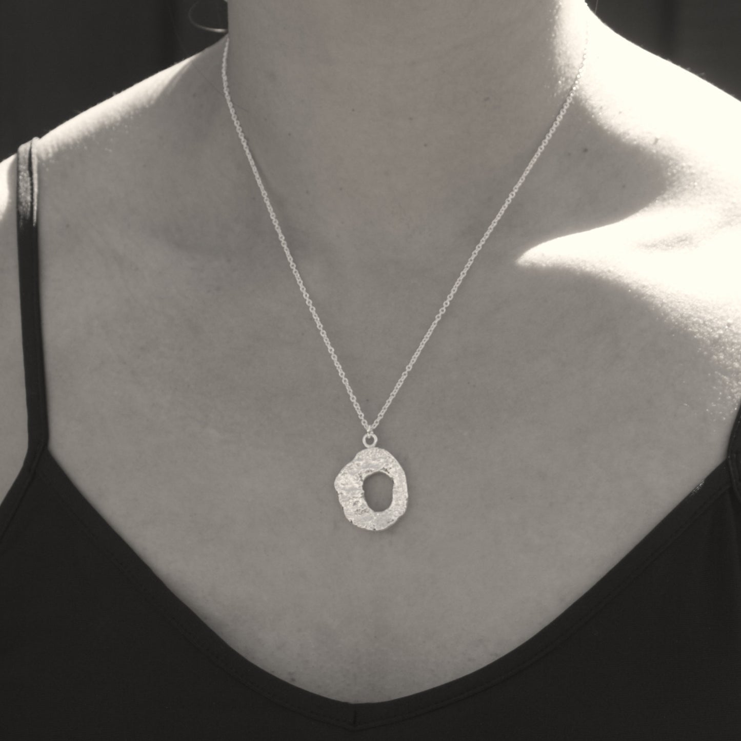 model wearing organic silver molten loop necklace