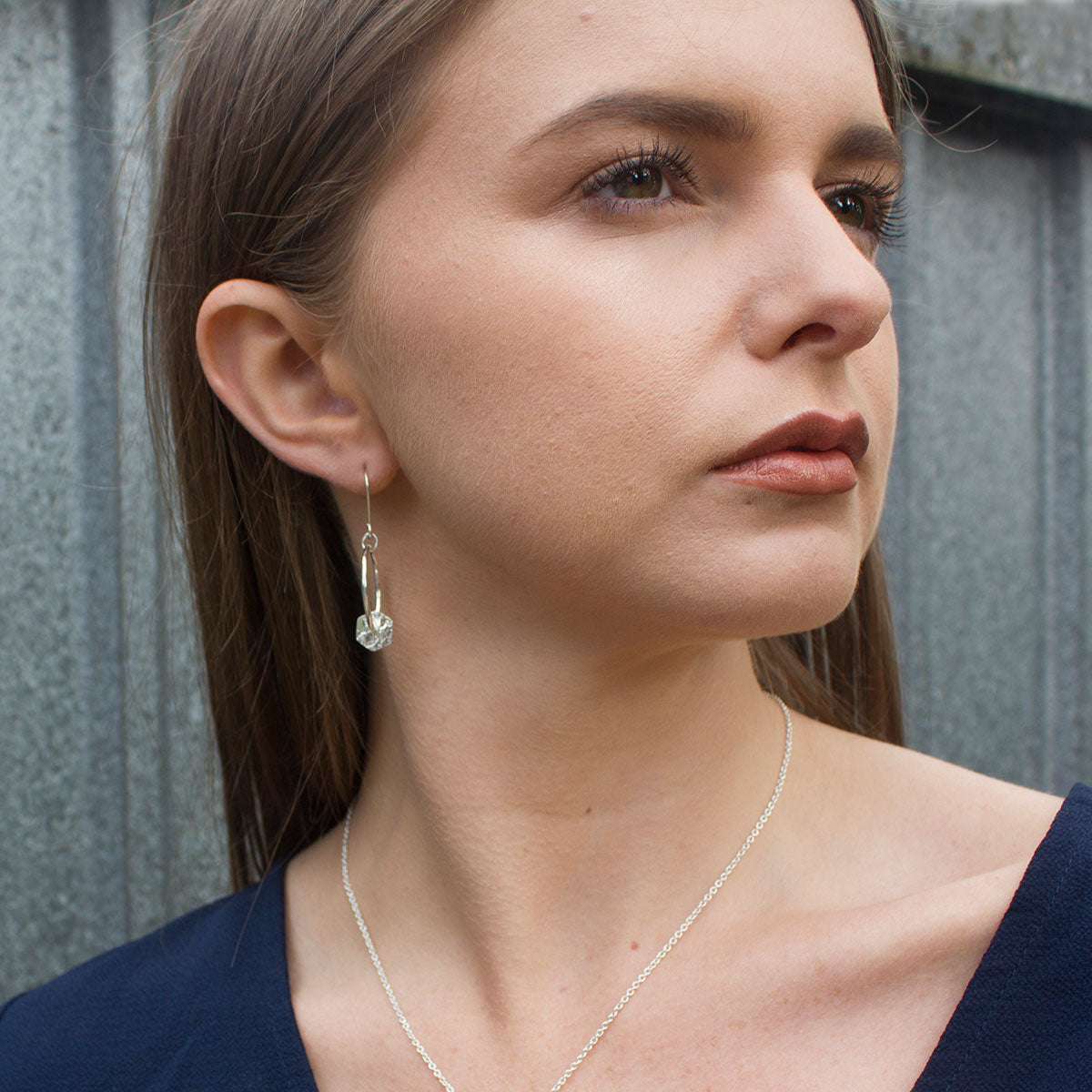 model wearing handmade silver textured hexagon hoop earrings