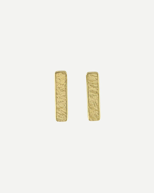 Front view of gold rectangle bar stud earrings with a delicate texture on white background