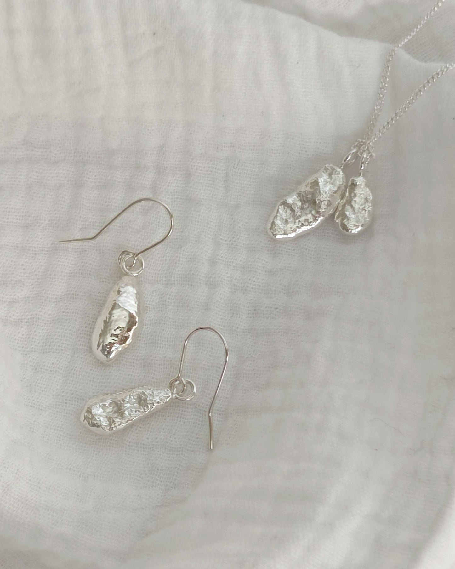 elegant sterling silver molten drop earrings on hooks by aurelium