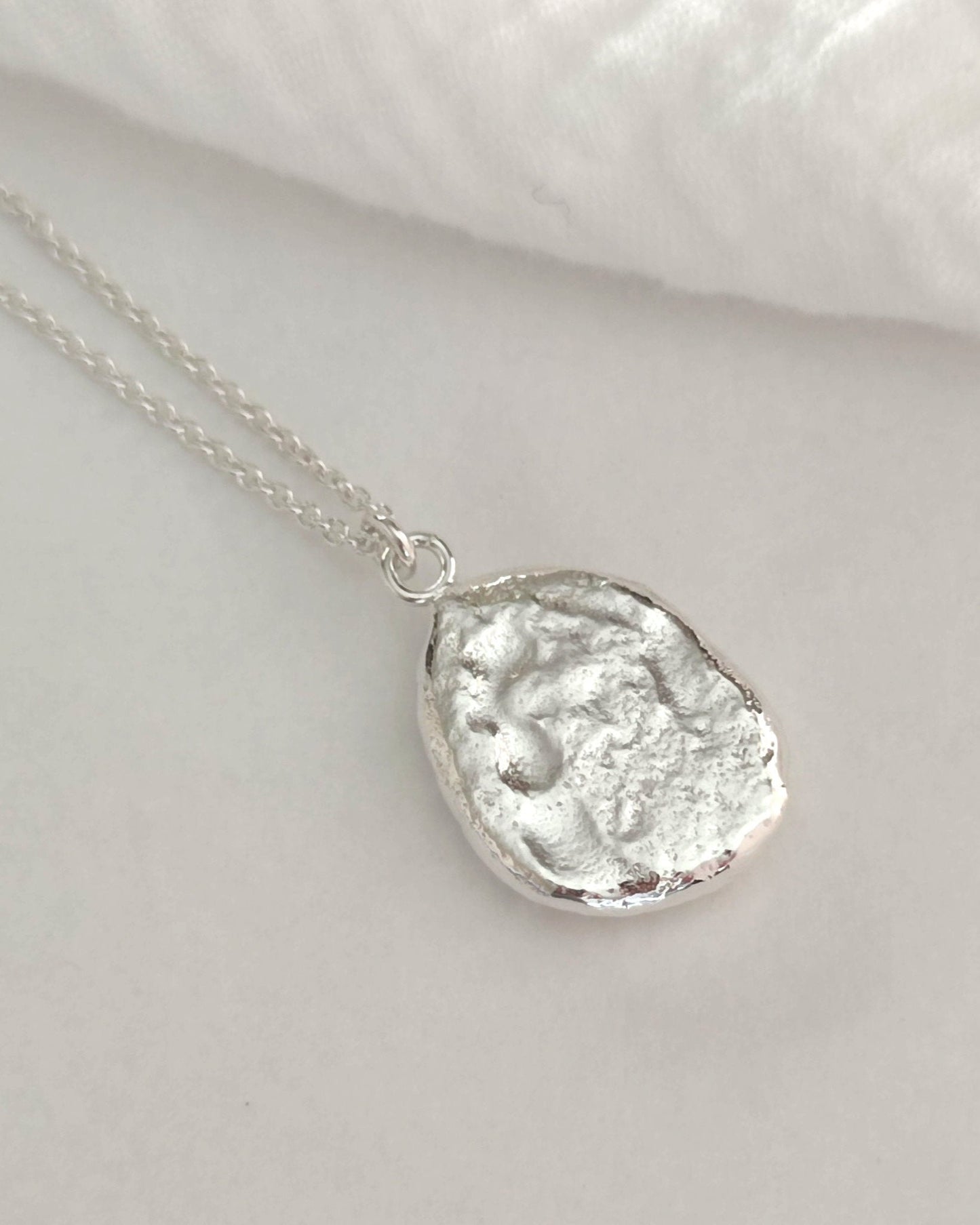 textured oval pendant made from recycled sterling silver