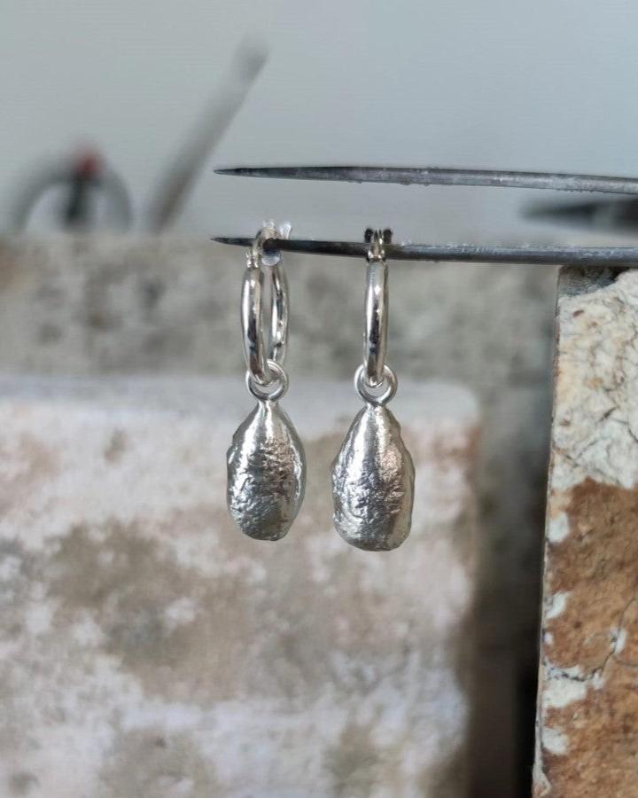 chunky molten sterling silver teardrop earrings in jewellery studio