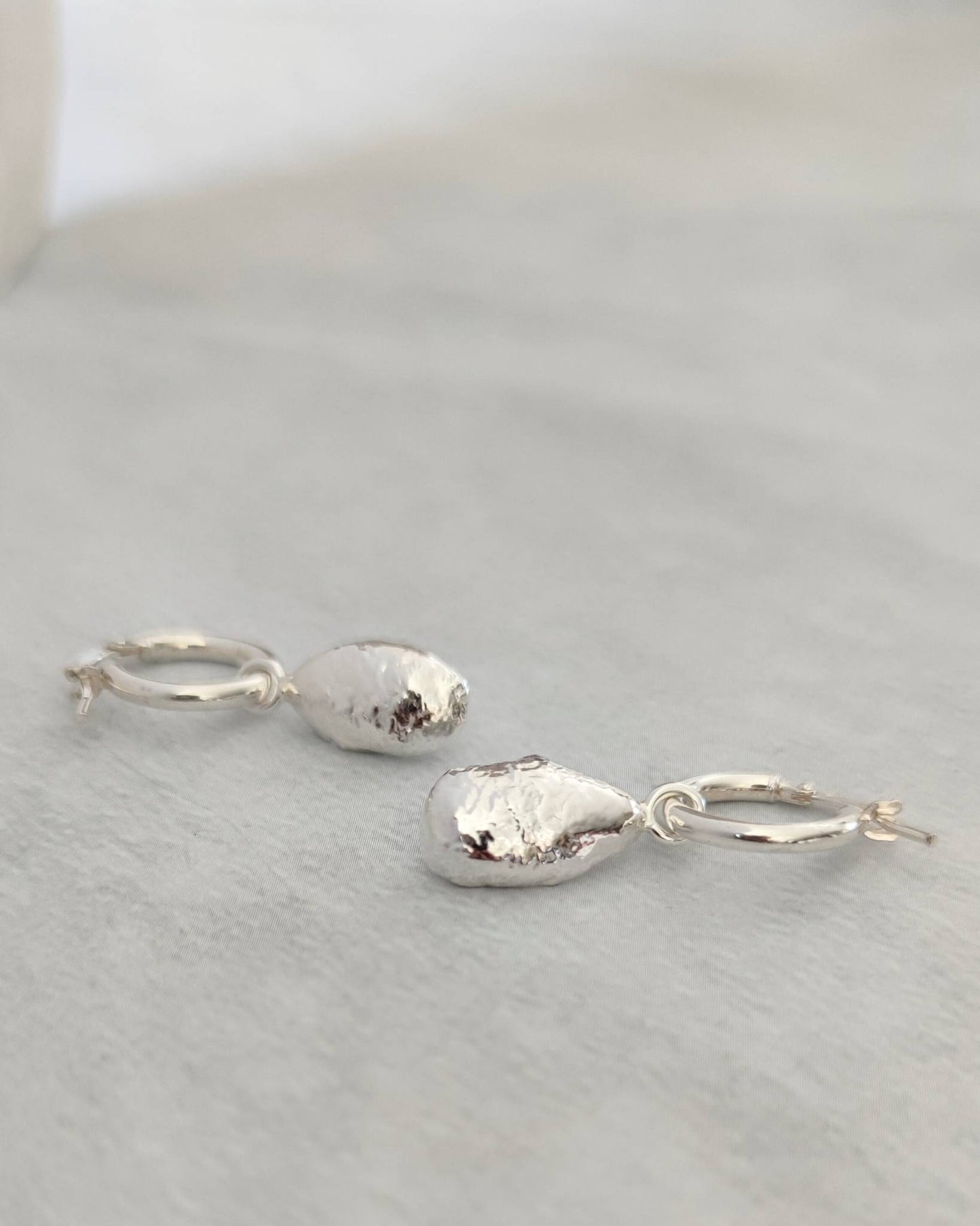 timeless organic molten silver droplet hoop earrings by aurelium nz