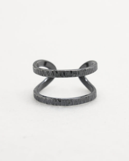 Front view of hammered adjustable oxidised silver ring with white background