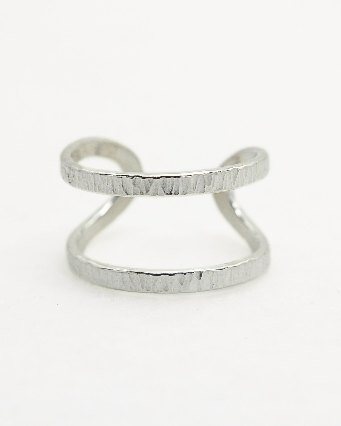 Front view of textured silver adjustable ring on white background