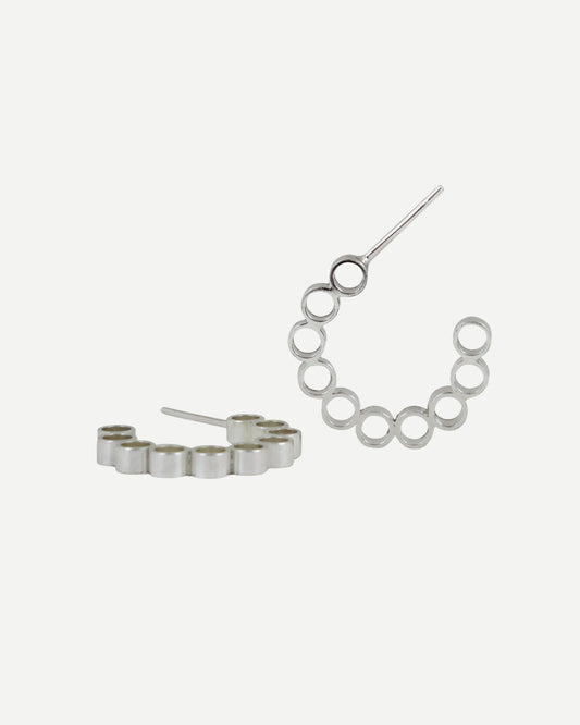 Sterling silver hoop earrings with contemporary circle design on white background