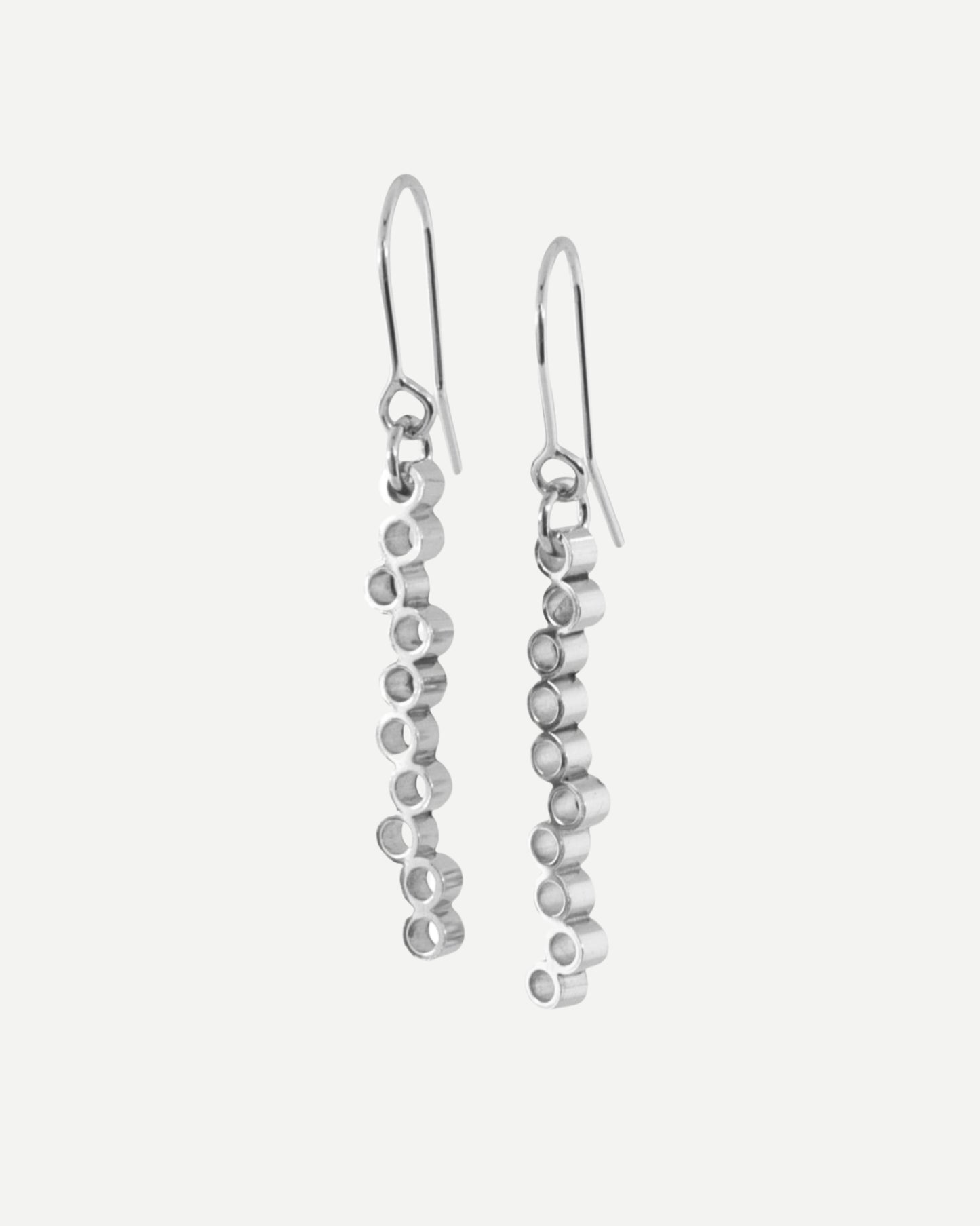 Long sterling silver dangly earrings with circle design hanging from silver hooks