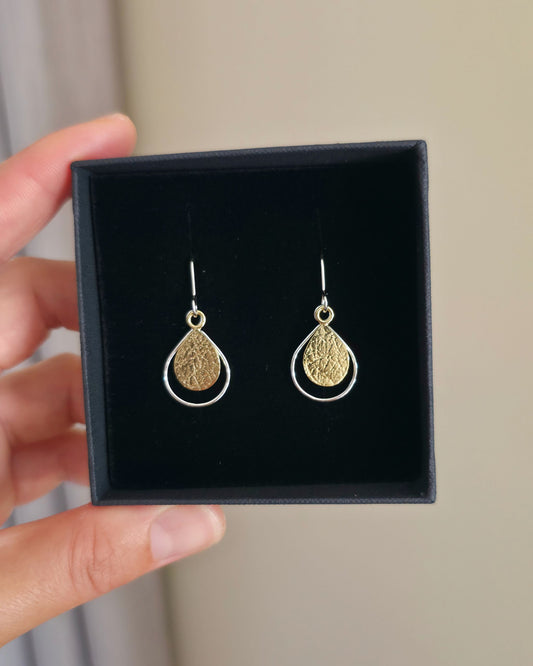 Textured gold teardrop earrings with silver border in black gift box