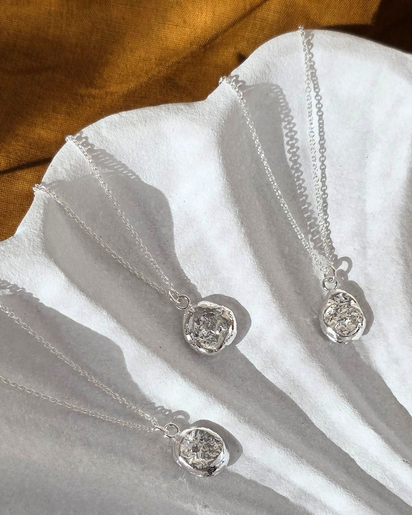 organic molten imprint pendants with textured surface
