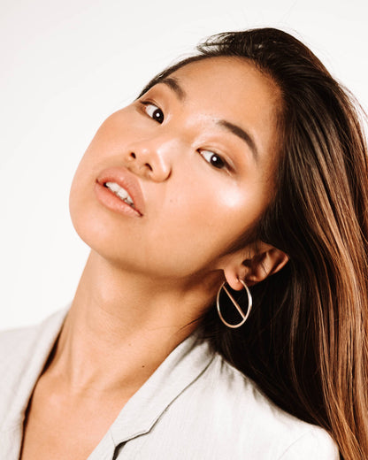 model wearing bold sterling silver slice earrings handmade by aurelium nz