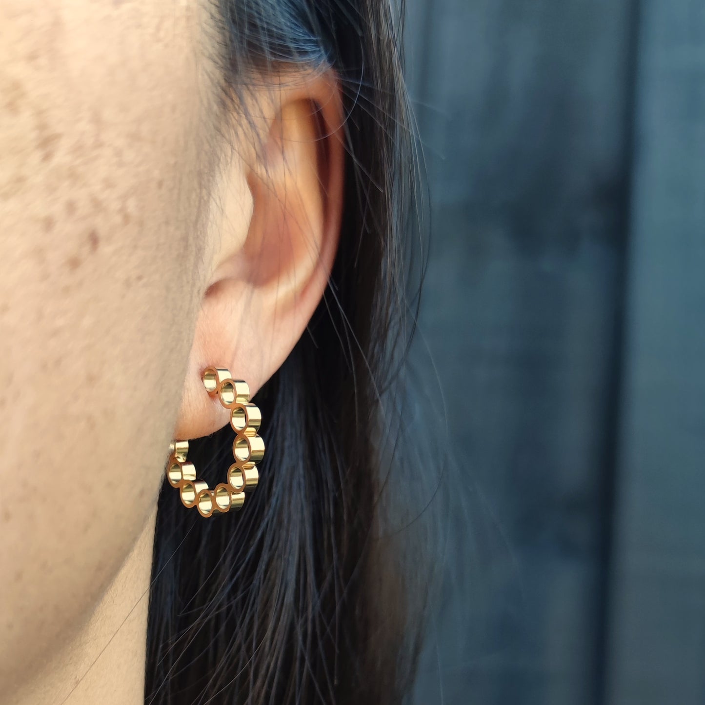 model wearing handmade gold elements hoop earrings