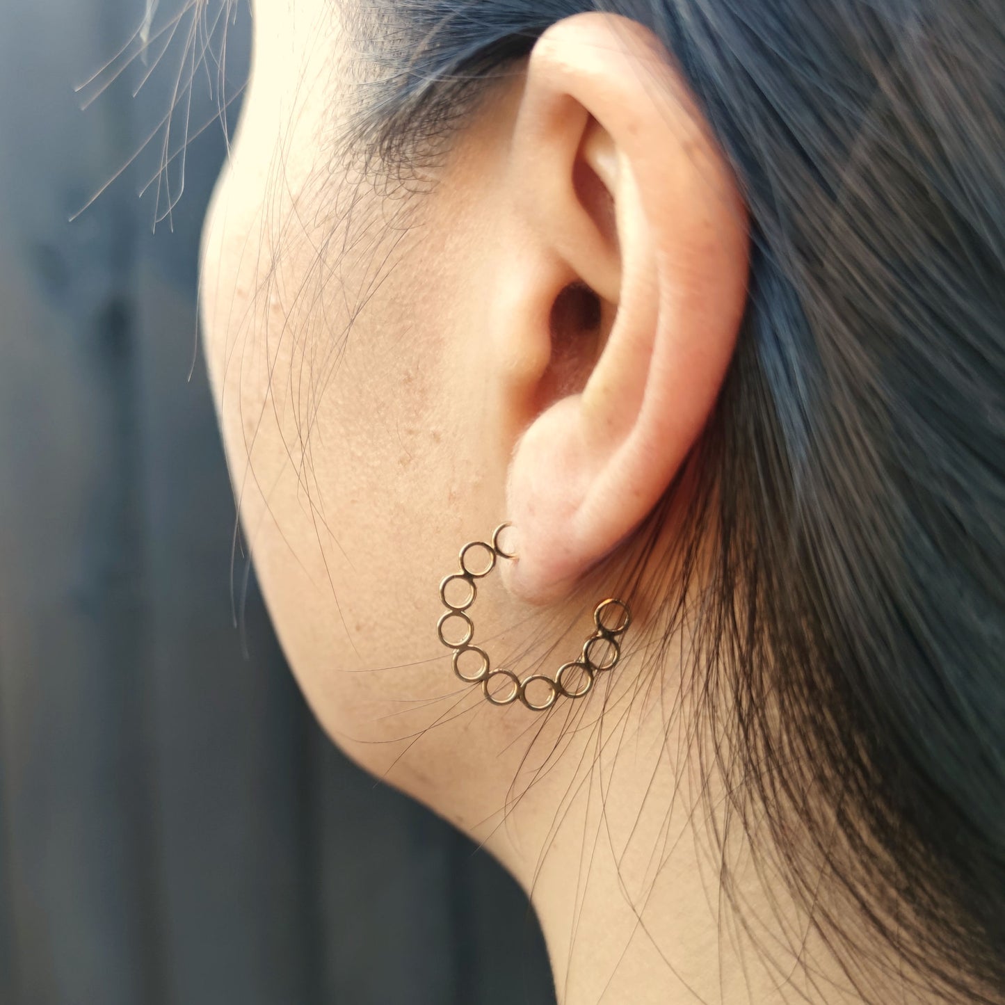model wearing handcrafted gold elements hoop earrings