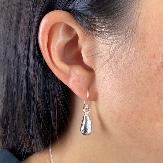 model wearing delicate molten sterling silver droplet earrings by aurelium