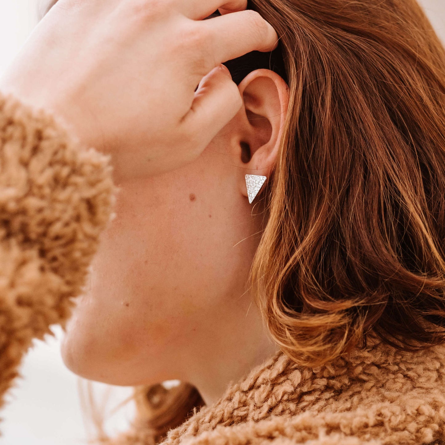 model wearing minimalist sterling silver textured triangle studs