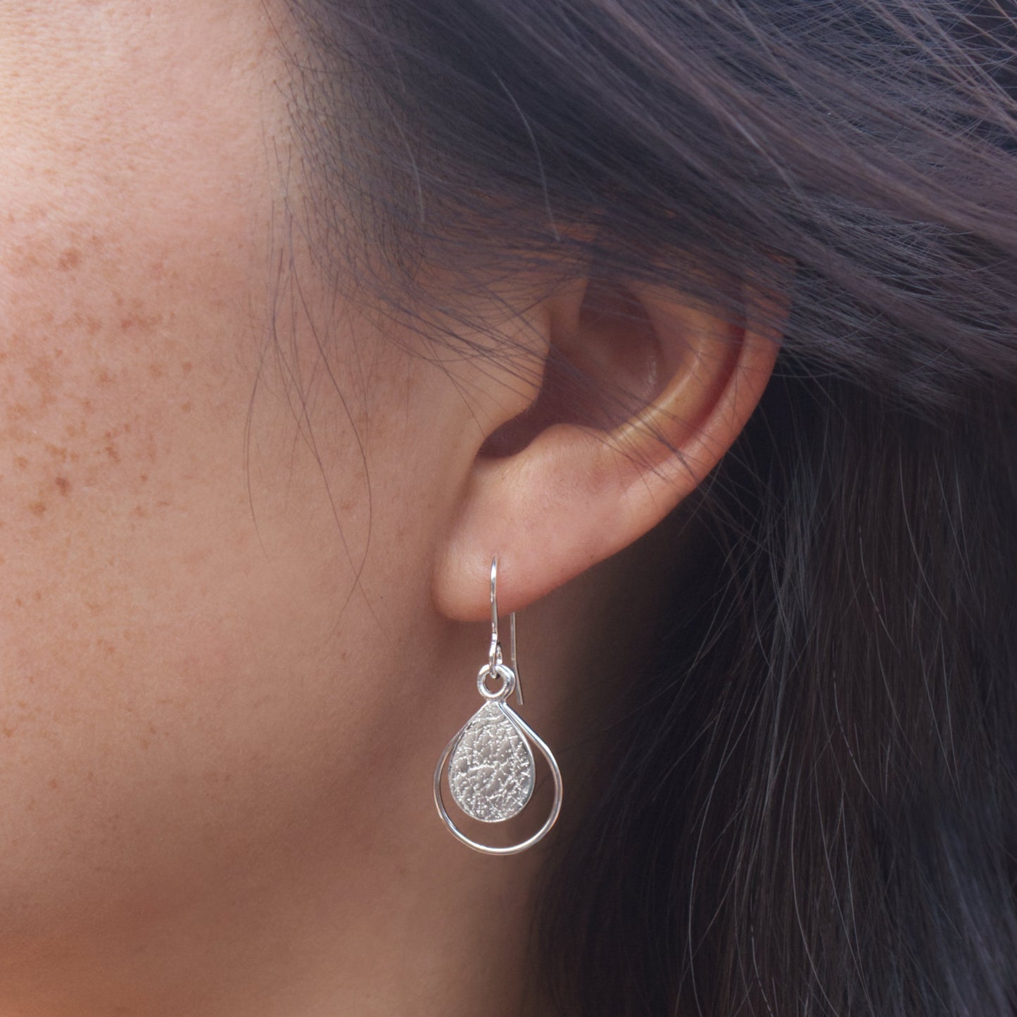 model wearing sterling silver textured dewdrop earrings