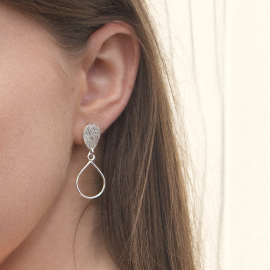 model wearing handmade sterling silver textured droplet earrings