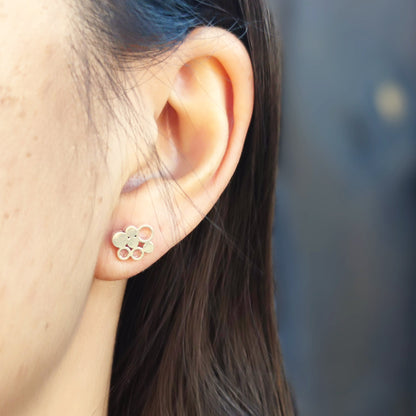 model wearing minimalist unique silver elements stud earrings