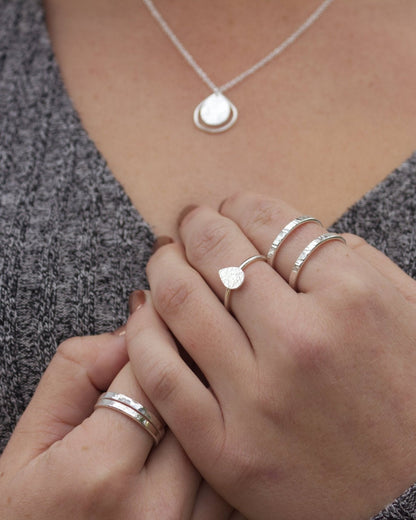 model wearing minimalist sterling silver textured stacking rings by aurelium nz