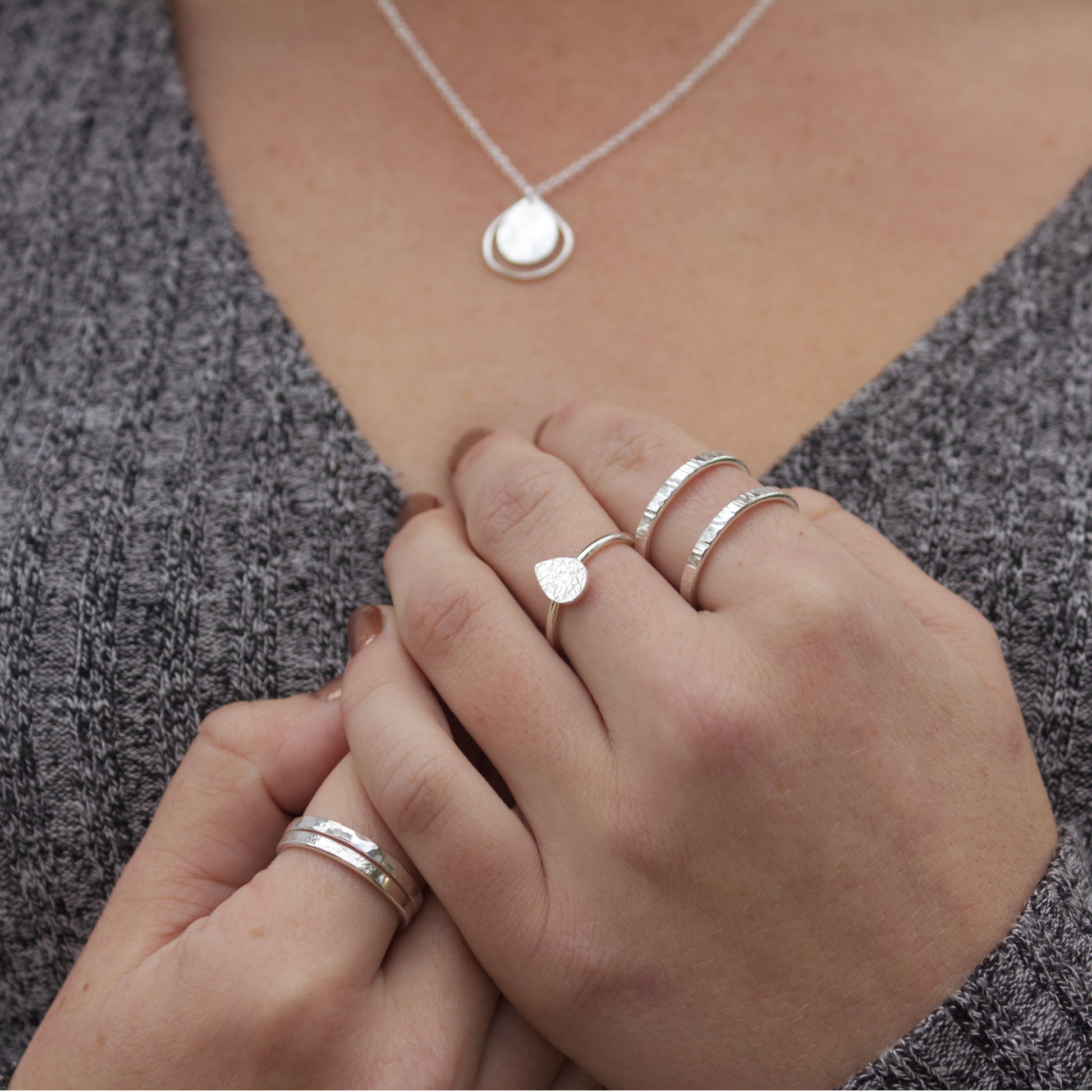 model wearing minimalist textured sterling silver adjustable ring