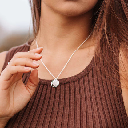model wearing simple textured circle necklace in sterling silver