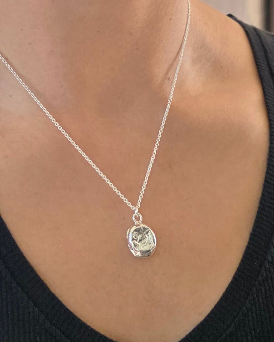model wearing molten sterling silver imprint oval necklace by aurelium nz