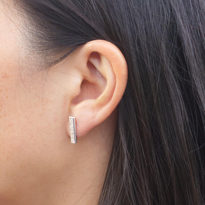 model wearing sterling silver textured bar earrings