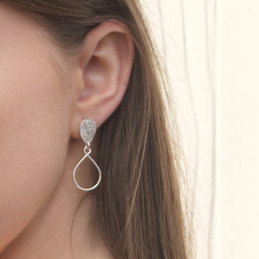 model wearing handmade sterling silver textured droplet earrings by aurelium nz