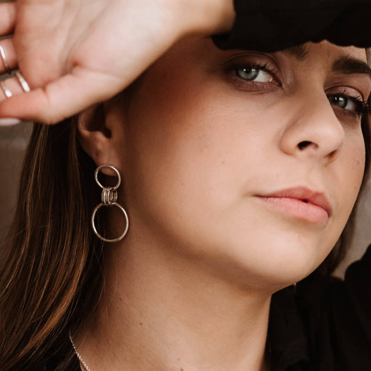 model wearing handcrafted sterling silver link drop earrings