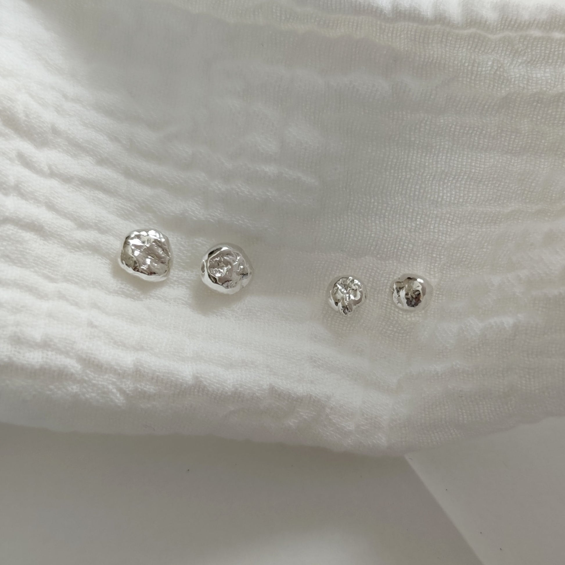 organic molten silver stud earrings with textured surface