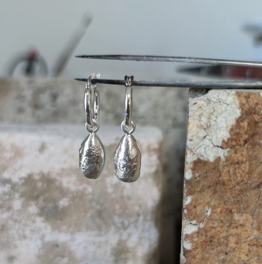 chunky molten sterling silver teardrop earrings in jewellery studio