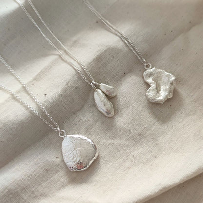 minimalist organic molten sterling silver pendants by aurelium jewellery