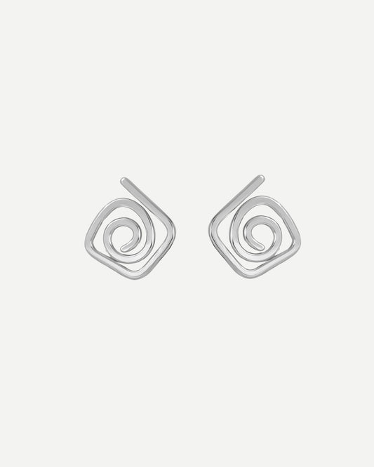 Pair of silver diamond shaped spiral stud earrings on a light grey background