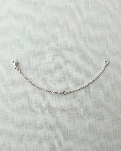 Sterling silver 10cm chain extender on textured paper background