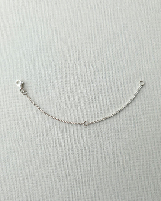 Sterling silver 10cm chain extender on textured paper background