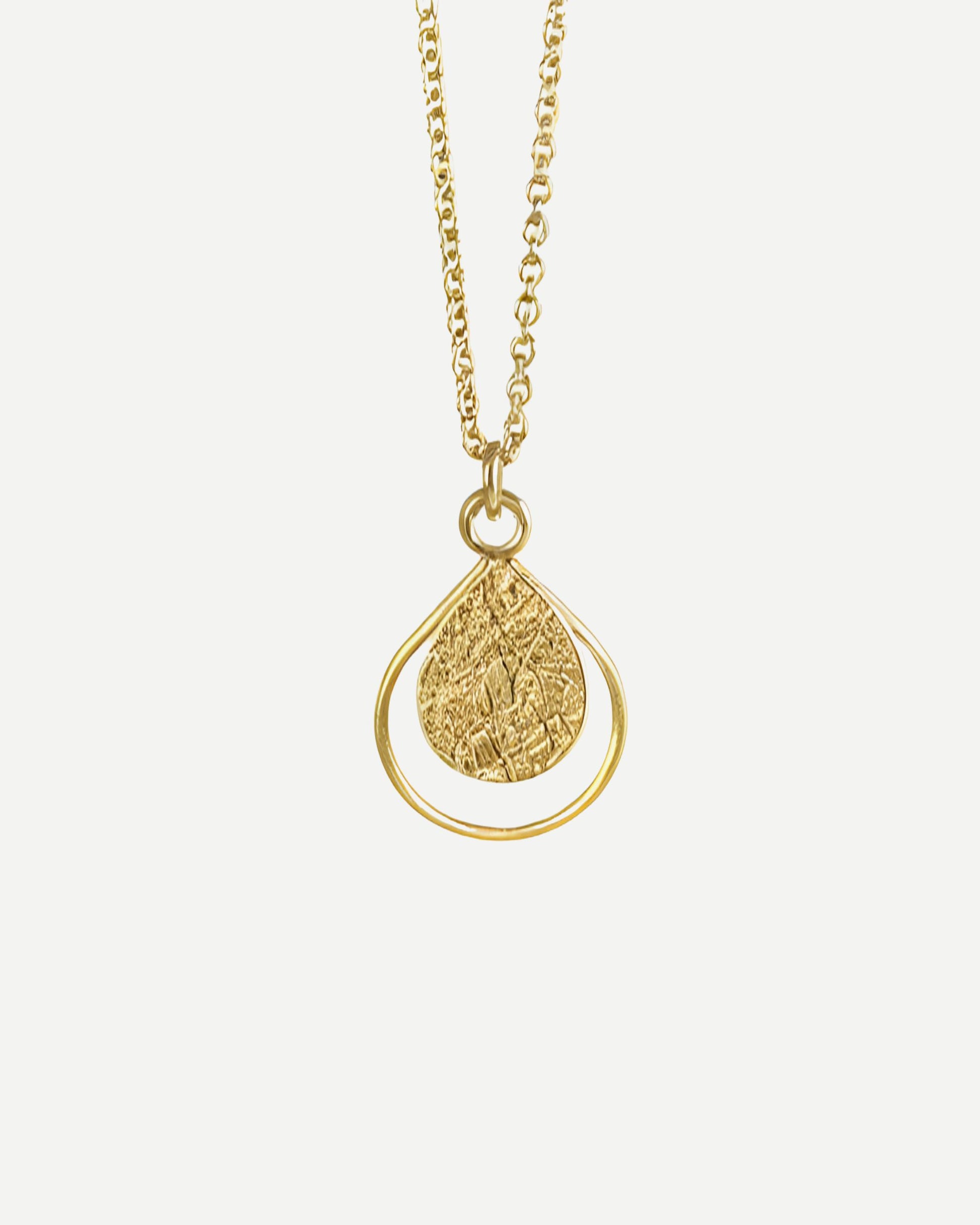 Gold necklace with a textured teardrop-shaped pendant on a white background
