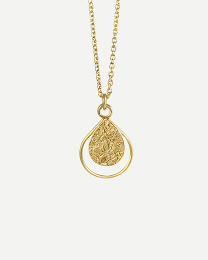 Gold necklace with a textured teardrop-shaped pendant on a white background