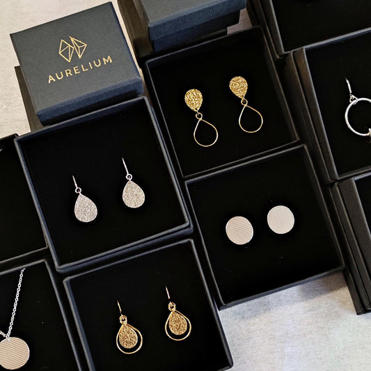 gold and silver aurelium jewellery in black gift boxes