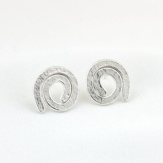 sterling silver mini swirl earrings on white background