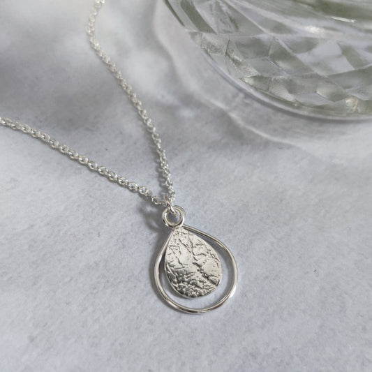 delicate sterling silver teardrop necklace by aurelium on marble surface