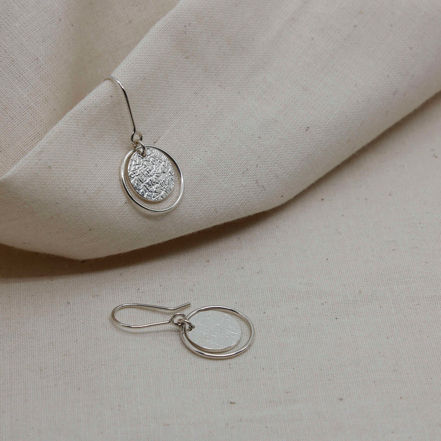 minimalist silver roundabout earrings with textured surface